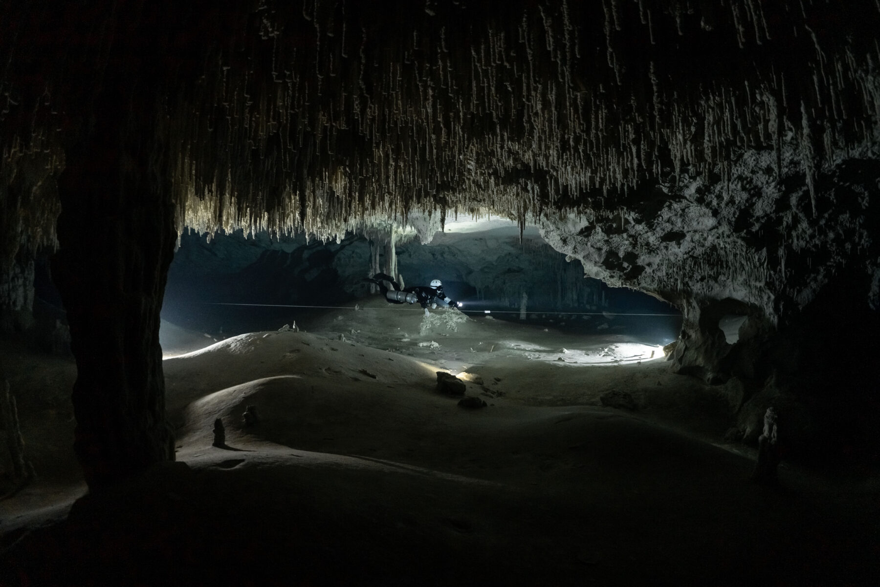 Photo credit: Natalie L Gibb, Under the Jungle A diver swims through the vast tunnels of Nohoch Nah Chich, part of the Sac Aktun cave system that has over 300 kilometers of surveyed tunnels